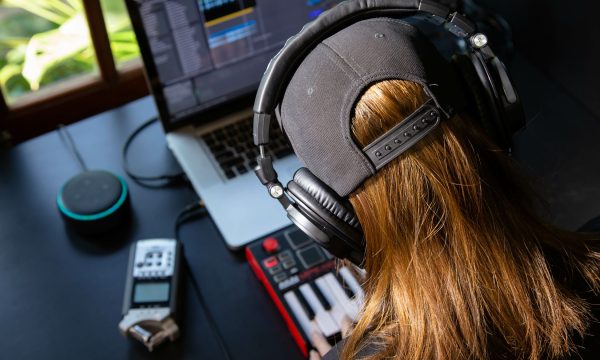 Close up of a female music producer with headphones in her home